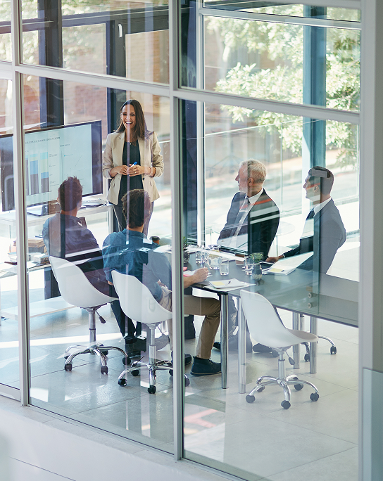 Professionals talking in a modern glass office