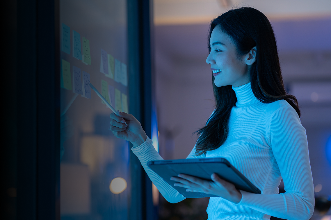 Woman interacting with a futuristic digital display