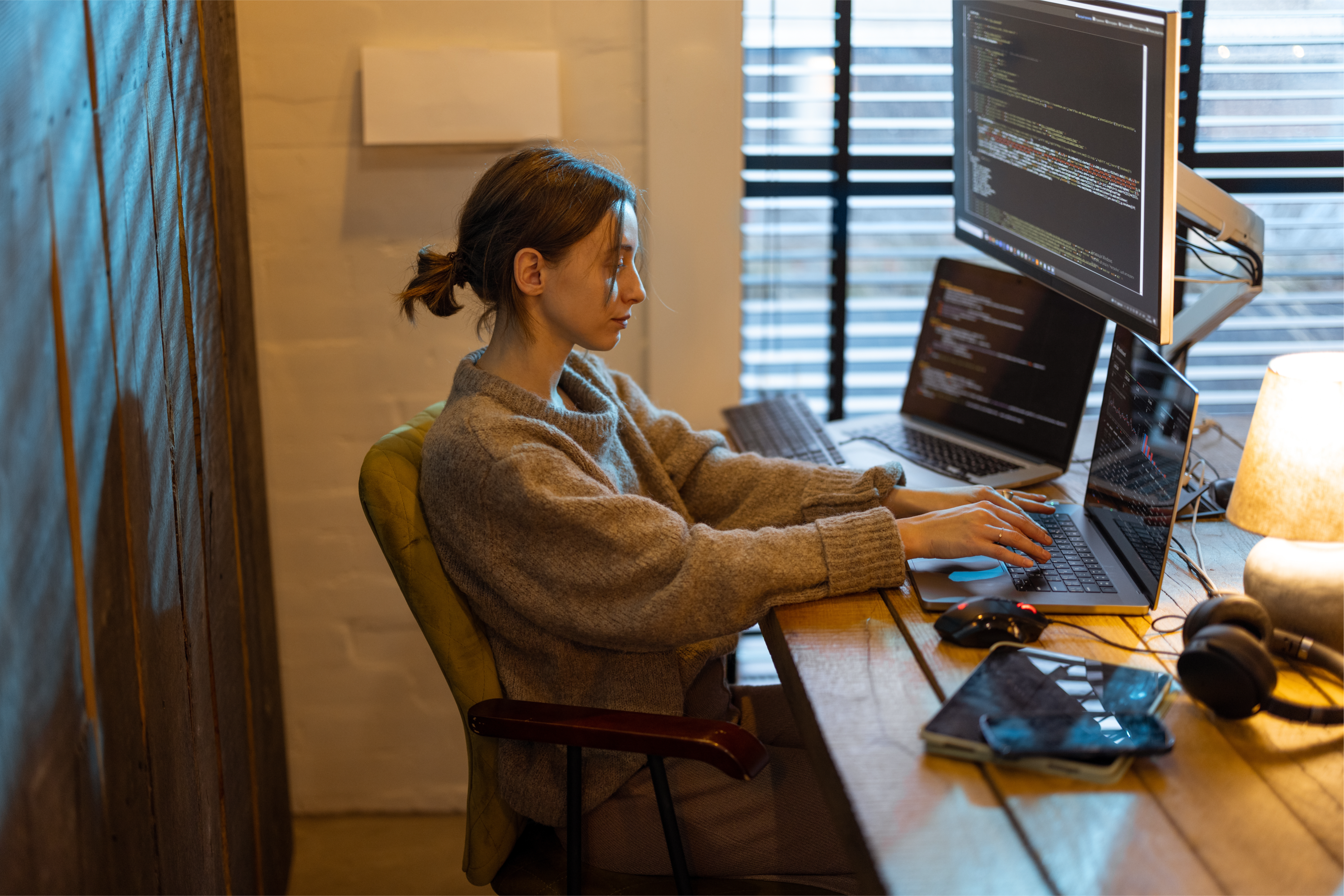 Person using a computer with multiple monitors, gamer setup