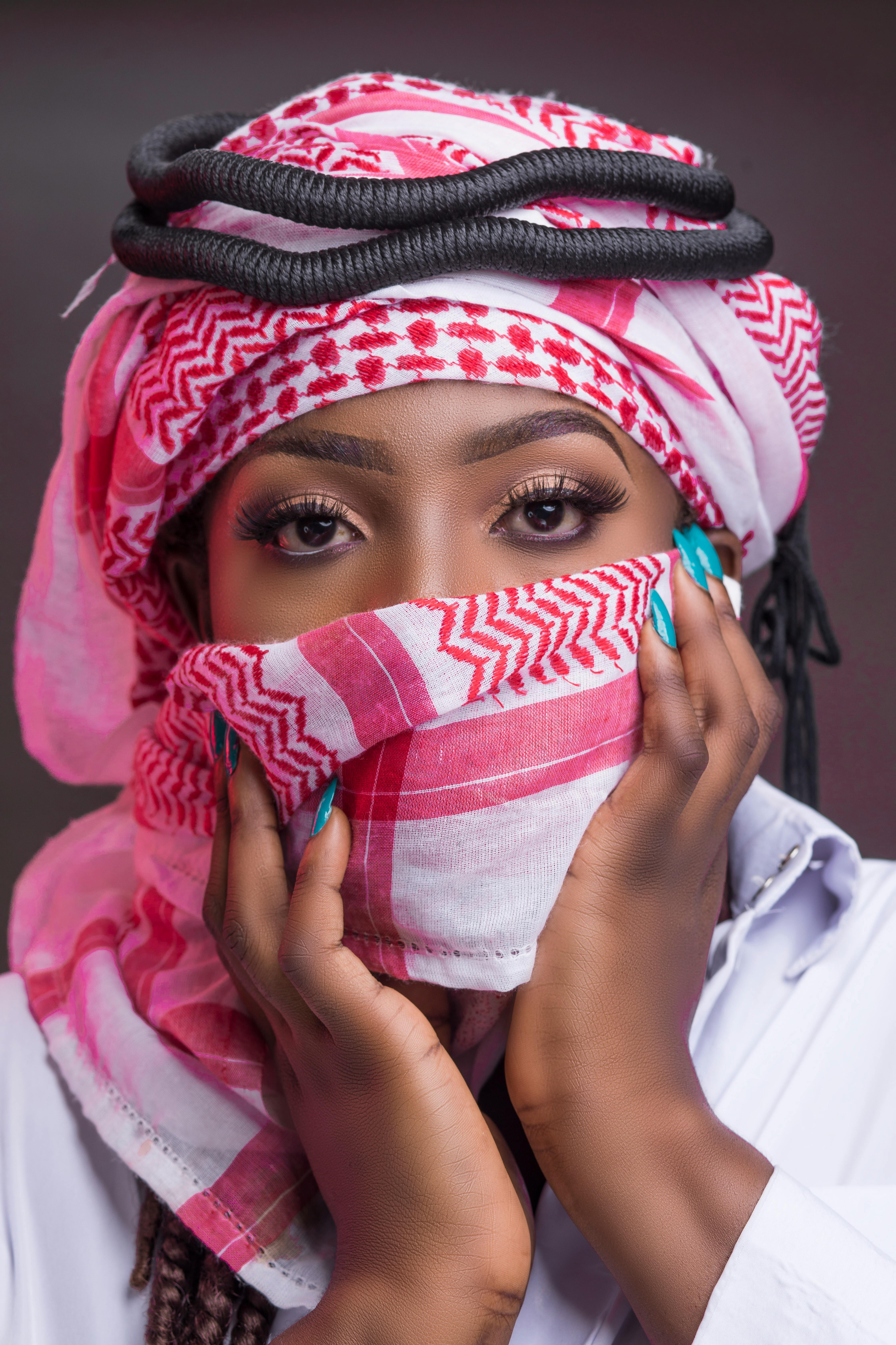 Portrait of a woman wearing a pink and white headscarf